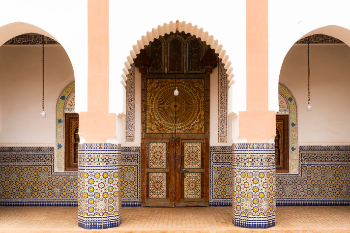 Entrance to the building with pillars and mosaic tiles